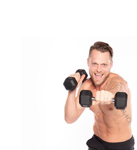Instructor Andrew Key shirtless with dumbbell in exercise position.