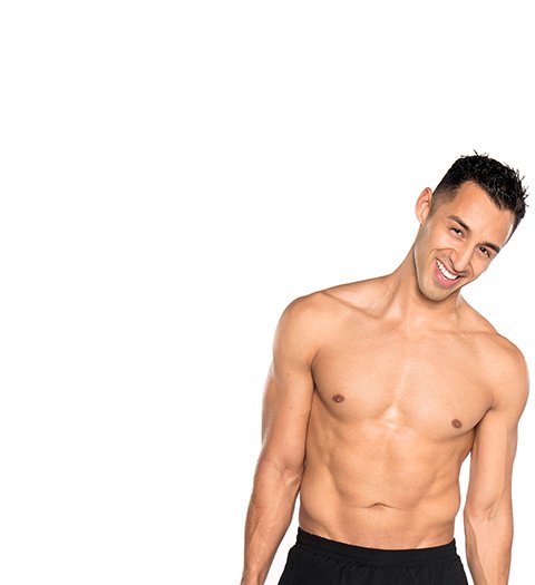 Shirtless Barry's Bootcamp instructor Andrew Nunez smiling on white background