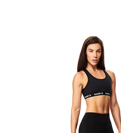 Instructor Brady Dougherty in black Barry's Bootcamp sports bra on white background