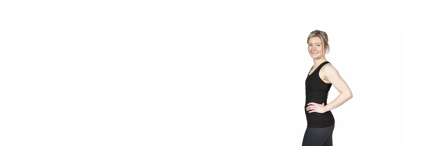 Barry's Bootcamp instructor Cecilie Sletteng in black tank top smiling with hand on hip on white background