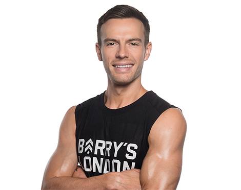 Headshot of Barry's Bootcamp instructor Chris Baxter crossing his arms against a white background.