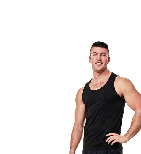 Barry's Bootcamp instructor Connor Miller in black tank top smiling with hand on hip on white background