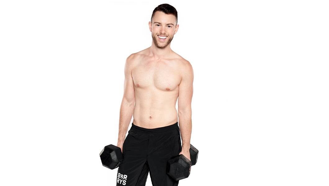 Barry's instructor David Petruzzi shirtless posing with barbells