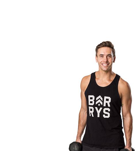 Barry's instructor Derek DeGrazio wearing a black tank top posing with dumbbells
