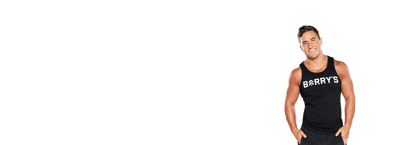 Instructor Erick Wilson in black Barry's Bootcamp tank top smiling on white background