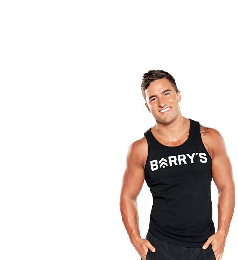 Instructor Erick Wilson in black Barry's Bootcamp tank top smiling on white background