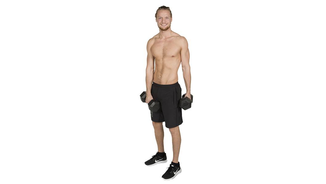 barry's instructor Erik Nordnes shirtless posing with dumbbells