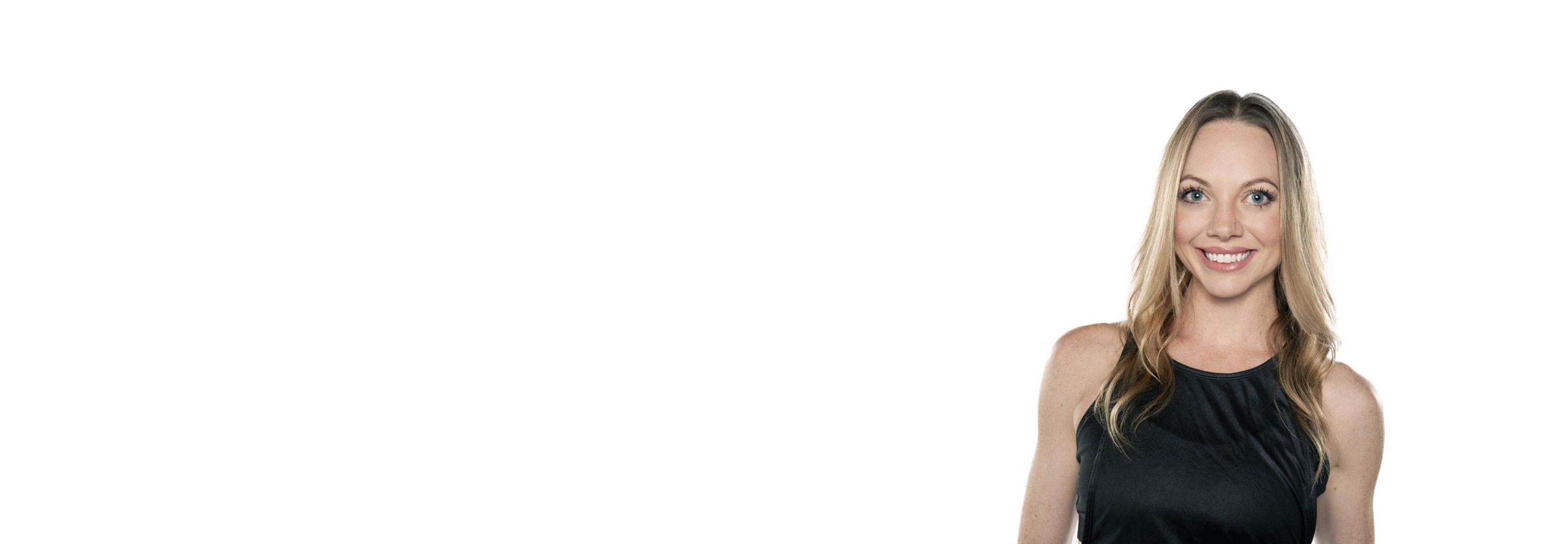 Barry's instructor standing confidently wearing a black tank top against a white background, ready for the next workout challenge.