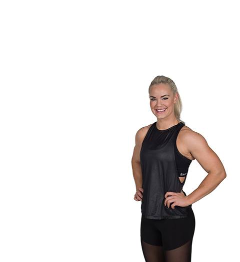 barry's instructor Fam Elgan in black tank posing with hands on hips