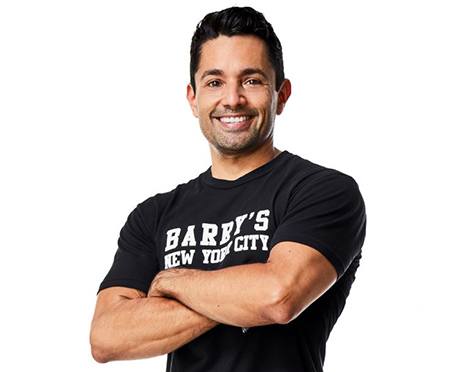 Headshot of Harley Rodriguez in a Black Barry's T shirt with arms folded
