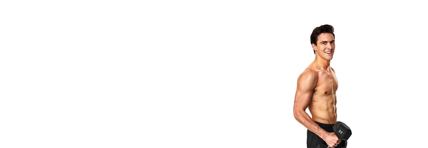 Shirtless Barry's Bootcamp instructor Jimmy Nicholas smiling while holding dumbbell on white background