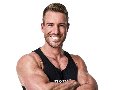 Headshot Barry's instructor Josey Greenwell in black tank posing with arms crossed