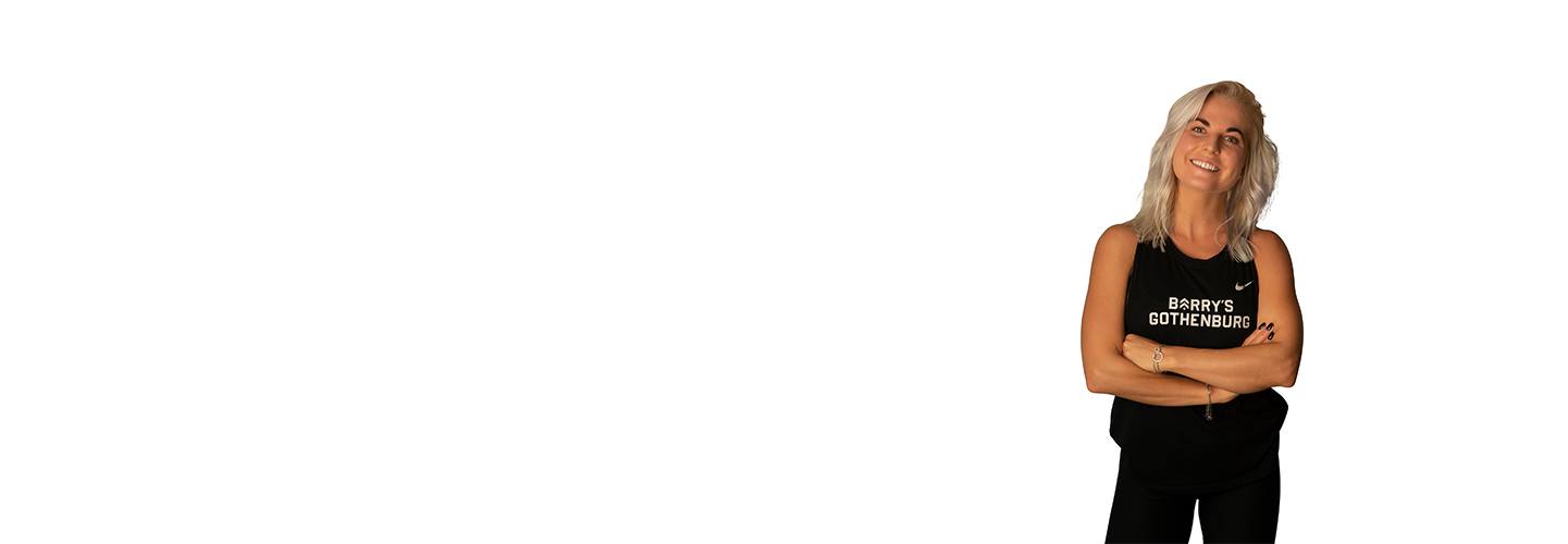 Headshot of Barry's Bootcamp instructor Karoline Pettersson wearing a black Barry's tank top with her arms crossed.