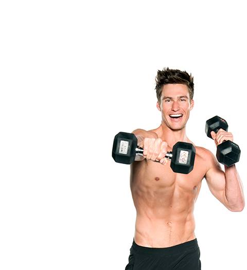 Shirtless Barry's Bootcamp instructor Matt W doing cross punch with dumbbells while smiling on white background
