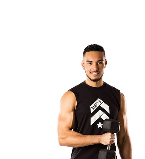 Barry's Instructor Miles Casey wearing black tank posing with dumbbell