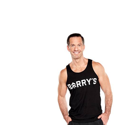 Barrys instructor Scott Haddock wearing black tank with hands in pockets