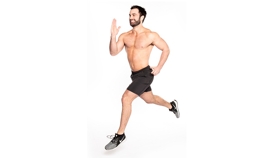 Barry's Bootcamp instructor Ben Zerbst shirtless in running position against white background.