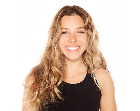 Headshot of Barry's Bootcamp instructor Giorgi smiling in a black tank top against a white background.