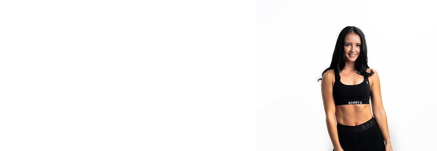 Barry's Bootcamp instructor Lorna Murphy on white background in fitness clothes smiling