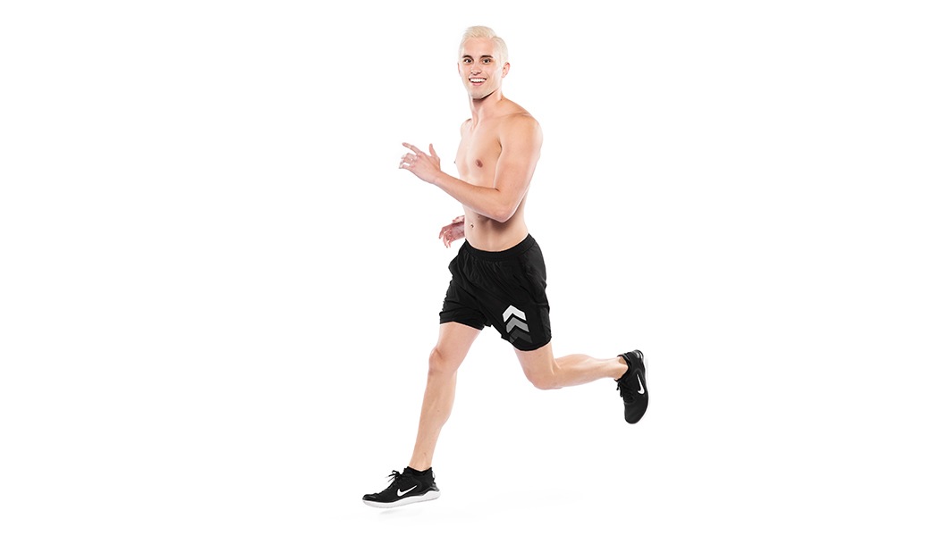 Barry’s instructor shirtless running confidently smiling against a white background