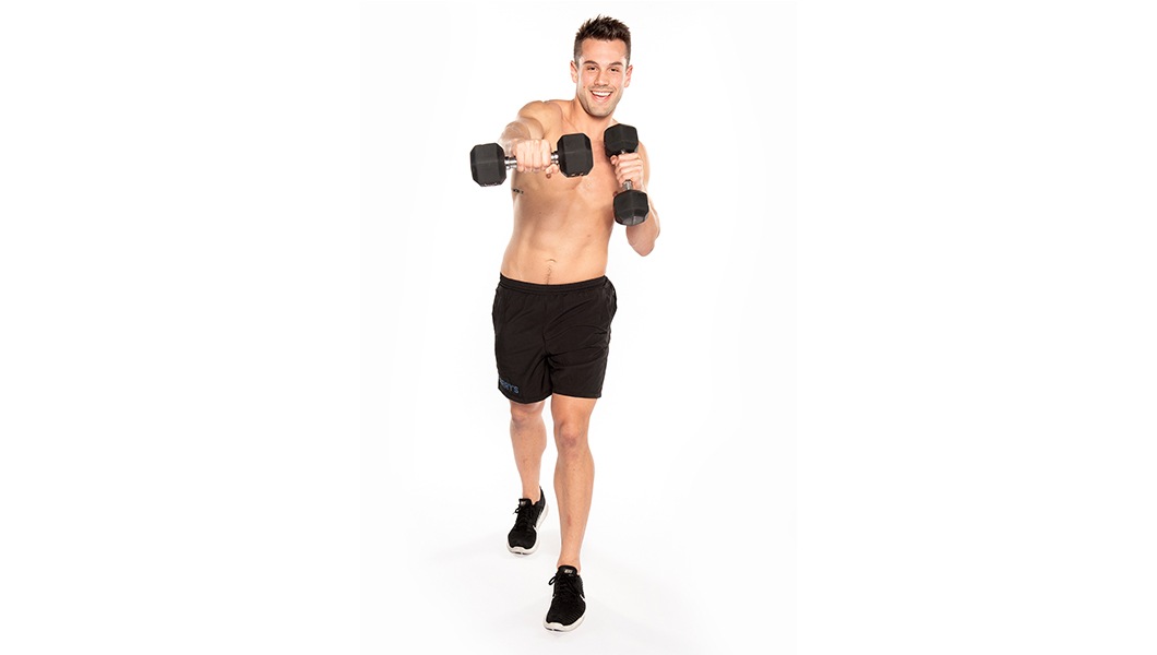 Barry's Bootcamp instructor Nick Tipple shirtless and punching while holding dumbbells against a white background.