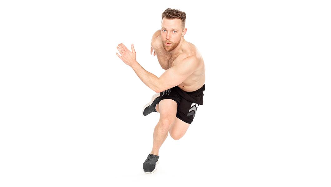 Barry's Bootcamp instructor Tommy Killen shirtless against a white background in a mid-running position.