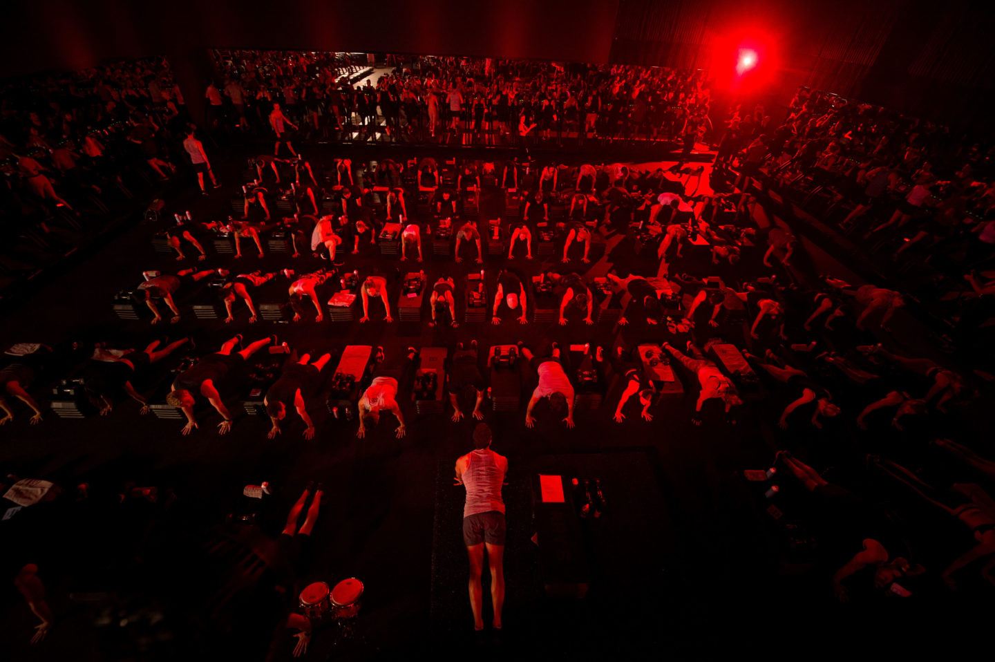 Large Barry's Bootcamp class doing planks in Red Room