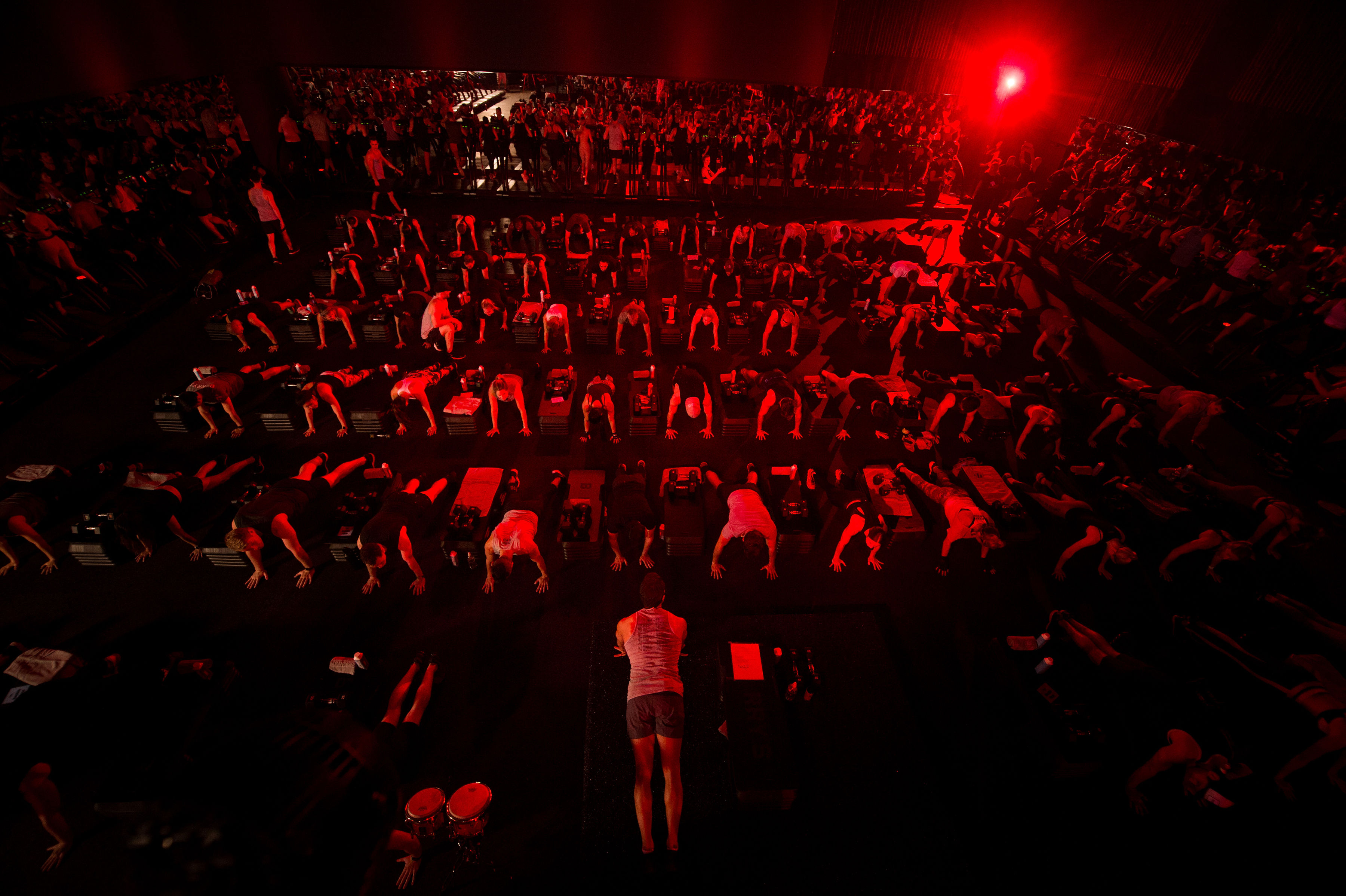 Large Barry's Bootcamp class doing planks in Red Room 
