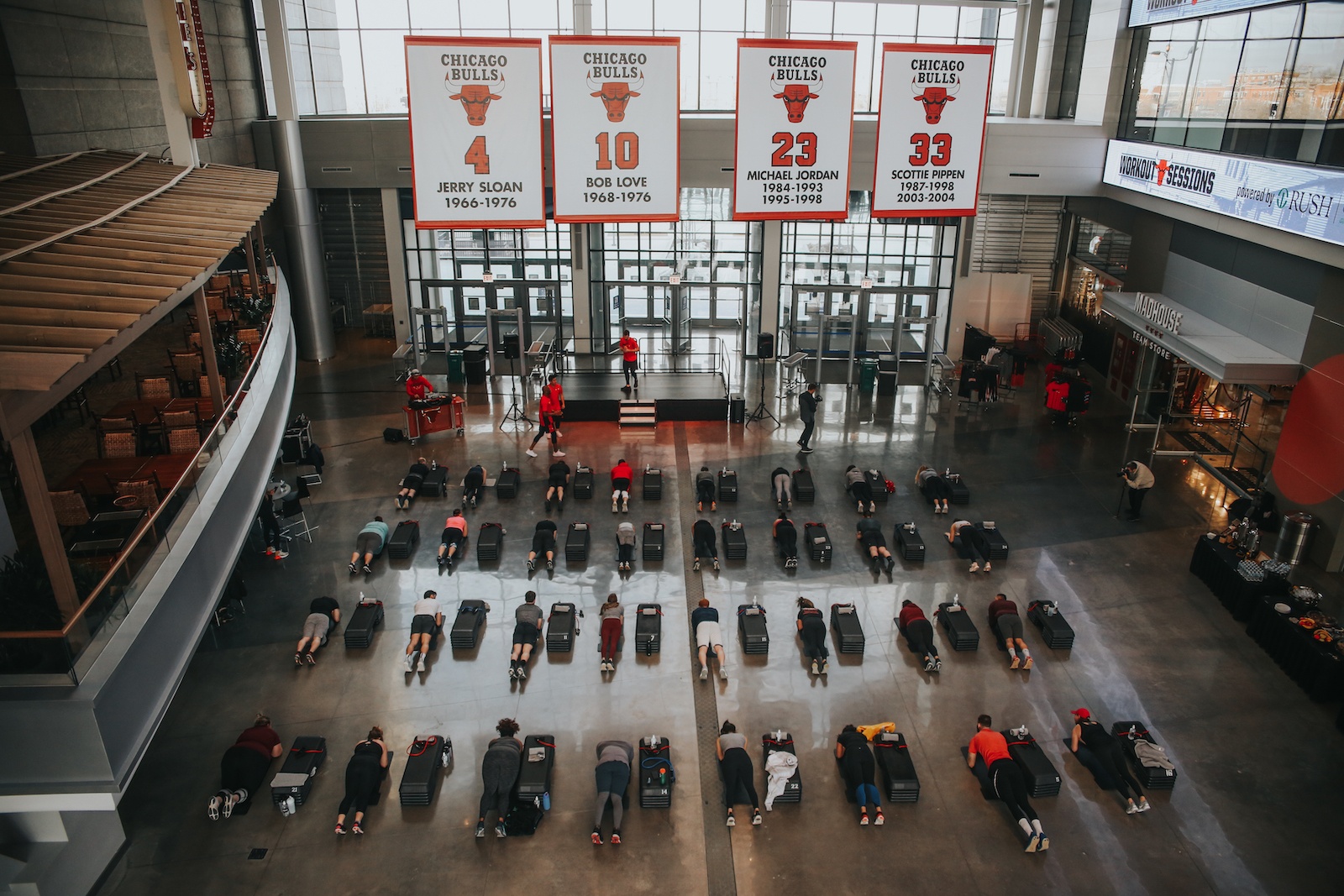 Overhead view of Barry's Bootcamp fitness class and Chicago Bulls banner in the United Center Atrium in Chicago