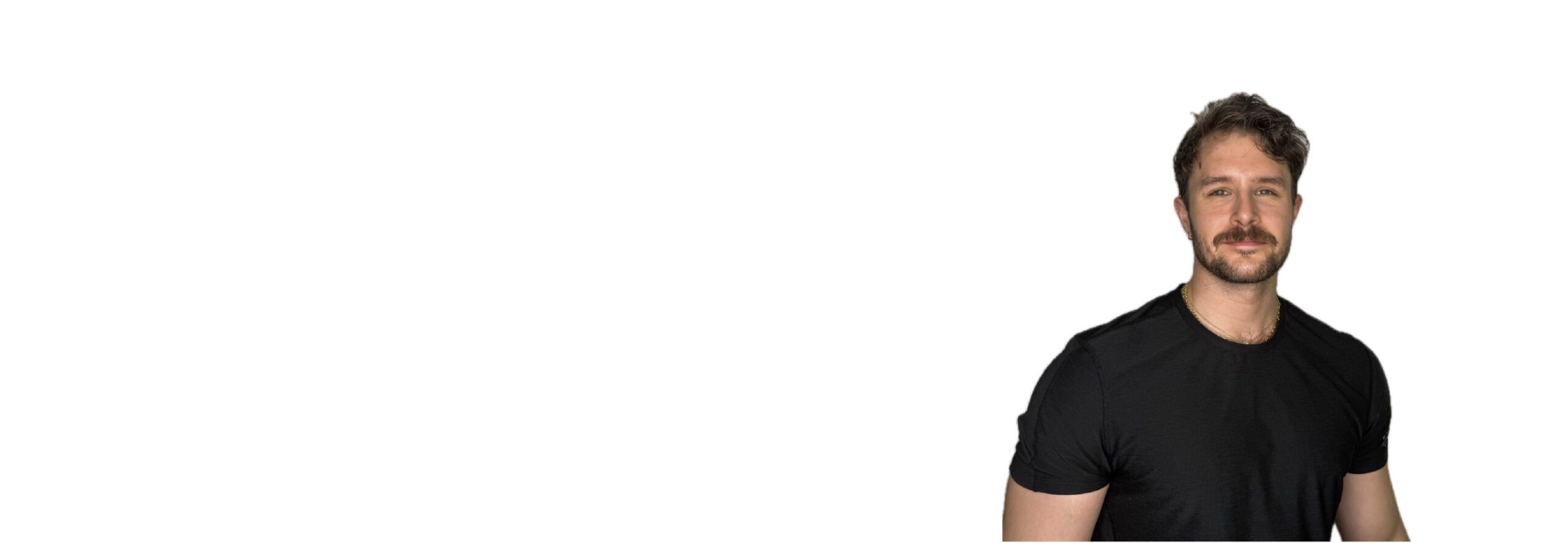 Barry’s instructor wearing a black top standing confidently smiling against a white background