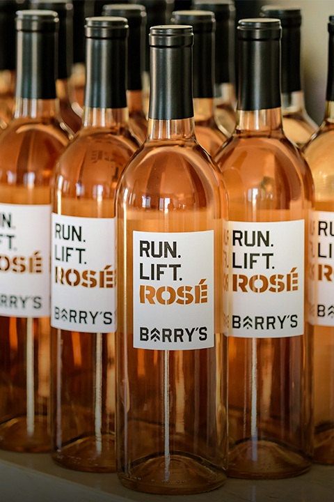 Barry's Bootcamp run lift rosé bottles sitting on shelf