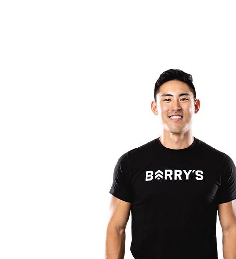 Barry's instructor standing confidently wearing a black top against a white background.
