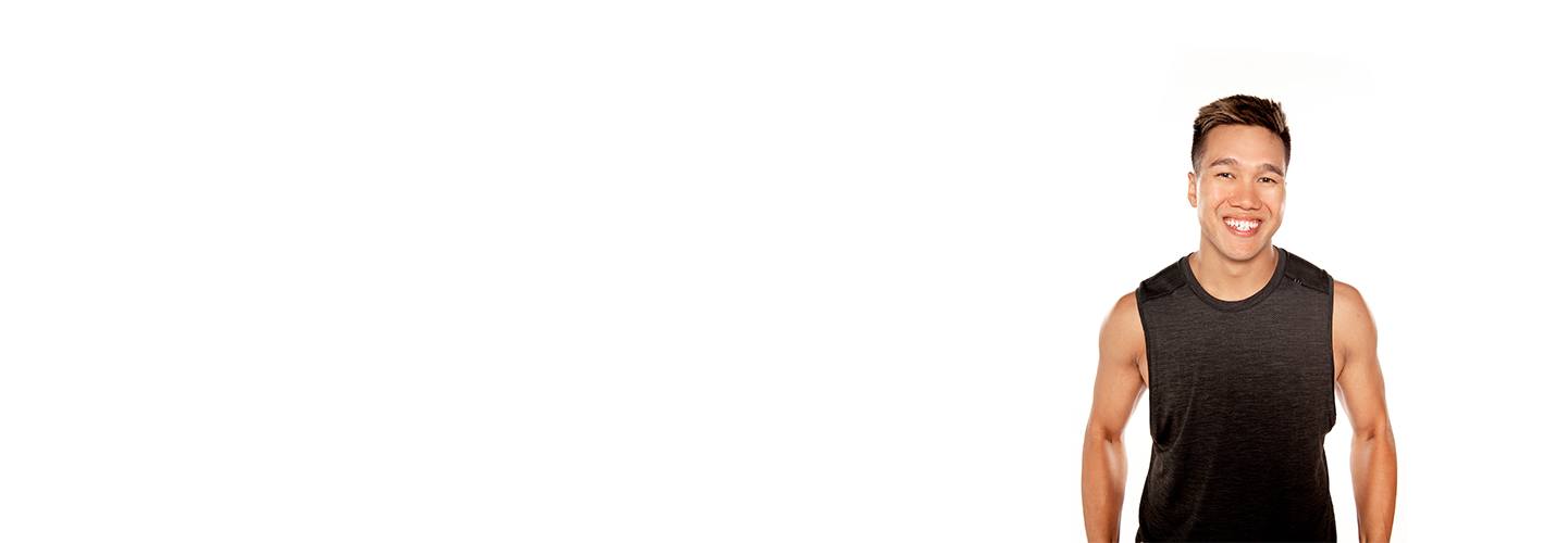 Barry's instructor standing confidently wearing a black tank top against a white background, ready for the next workout challenge.