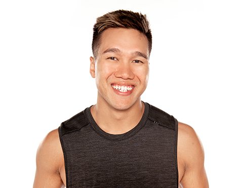 Barry's instructor standing confidently wearing a black tank top against a white background, ready for the next workout challenge.