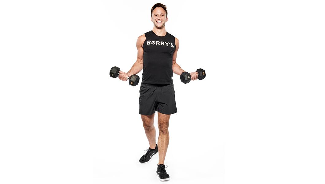 Barry's instructor in a black outfit holding weights out to the side against a white background.