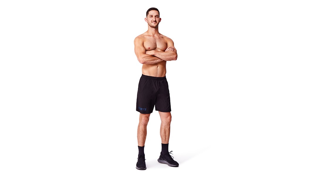 Barry’s instructor shirtless standing confidently against a white background