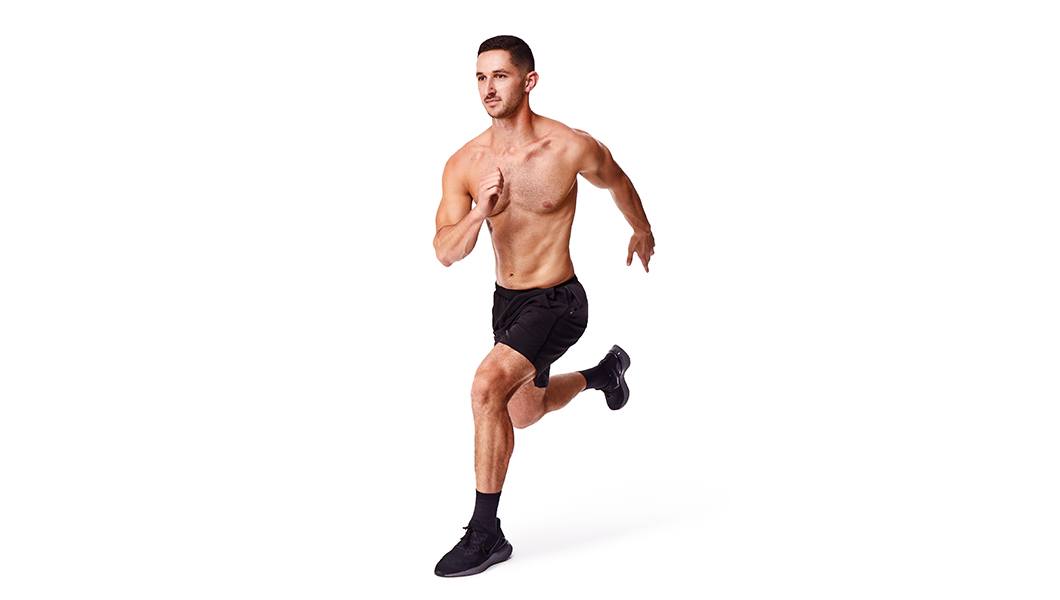 Barry’s instructor shirtless running confidently against a white background