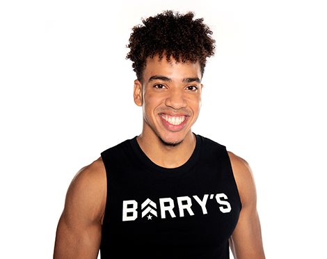 Barry's instructor standing confidently wearing a black top against a white background.
