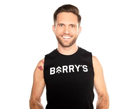 Barry's instructor standing confidently wearing a black top against a white background.