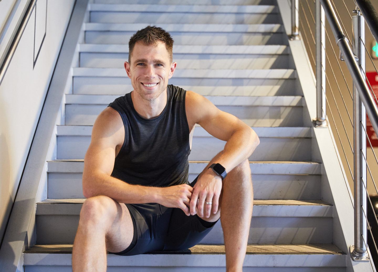 Barry’s Master Trainer, Chris Tye Walker, sitting on a staircase