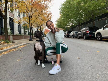 Senior Instructor, Mercedes Owens, and her dog posing in the street