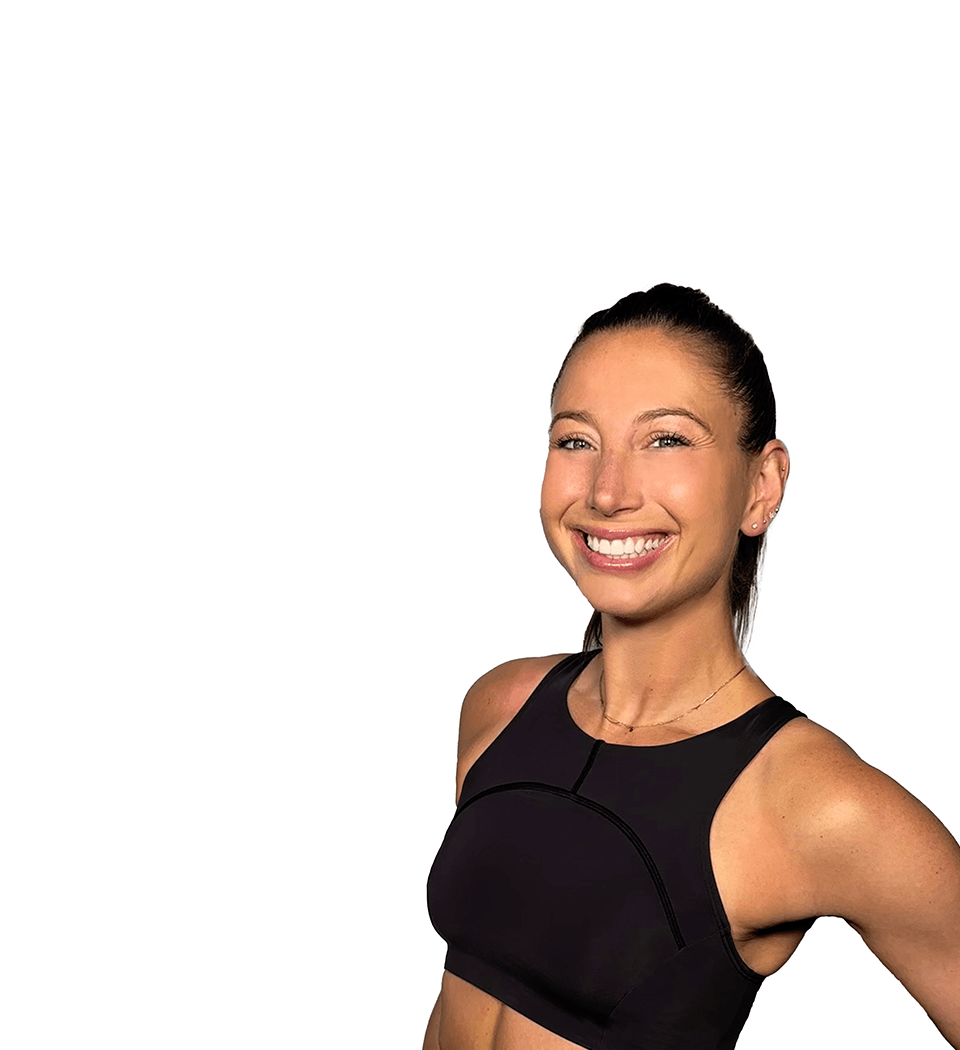 Barry’s instructor wearing a black top standing confidently smiling against a white background