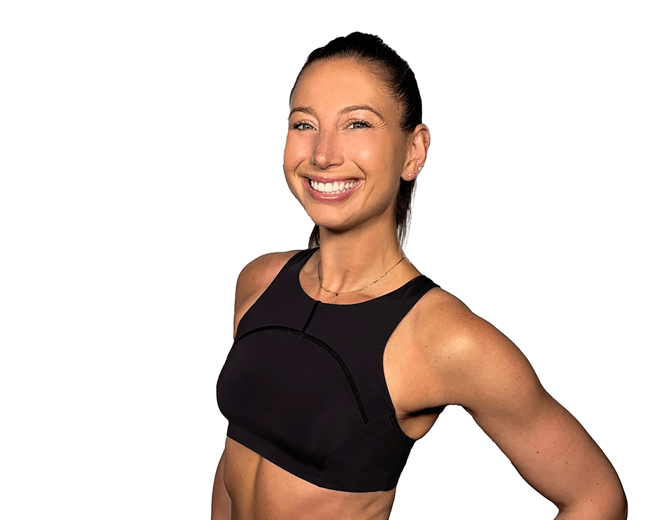 Barry’s instructor wearing a black top standing confidently smiling against a white background
