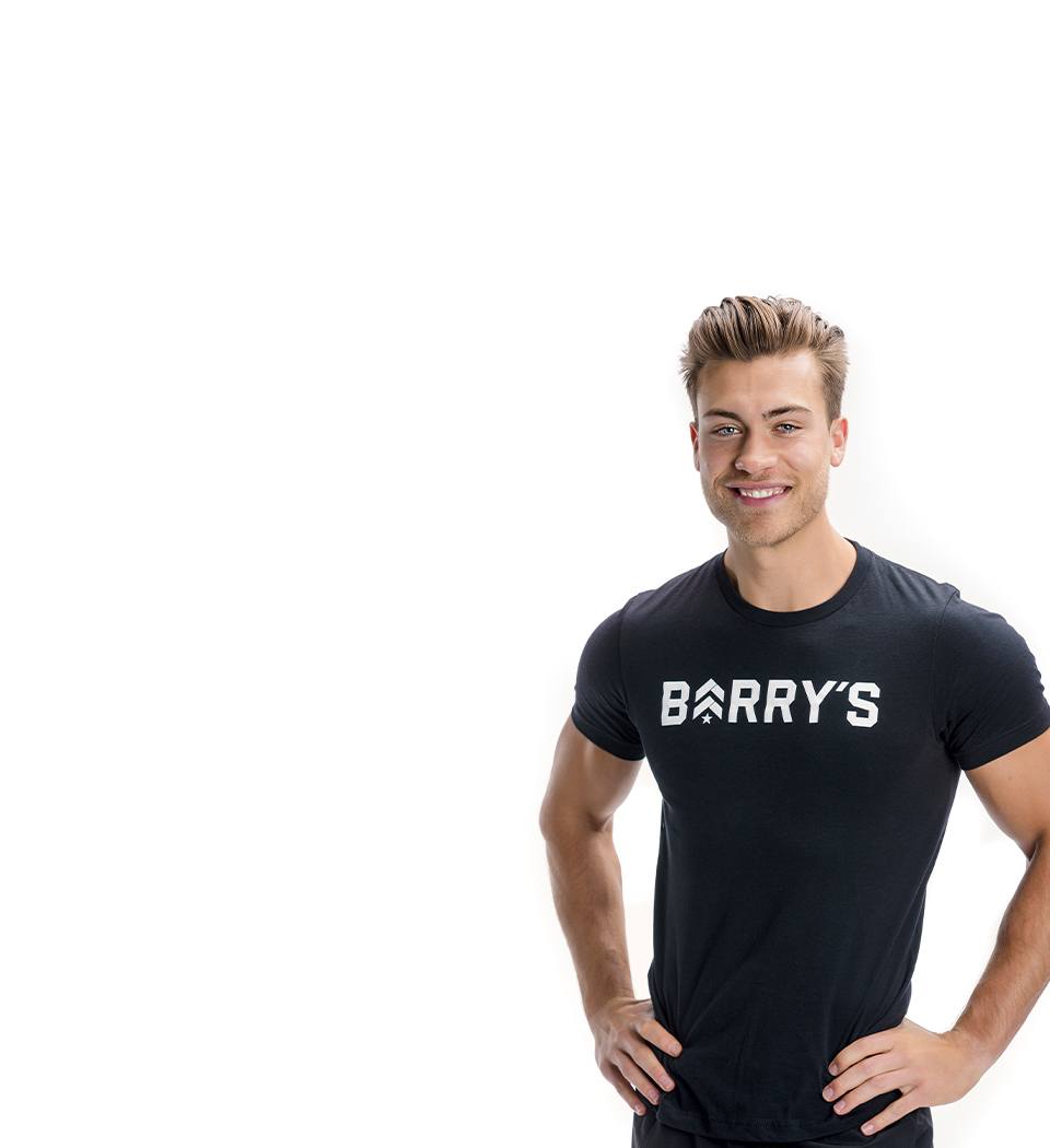 Barry's instructor standing confidently wearing a black top against a white background.