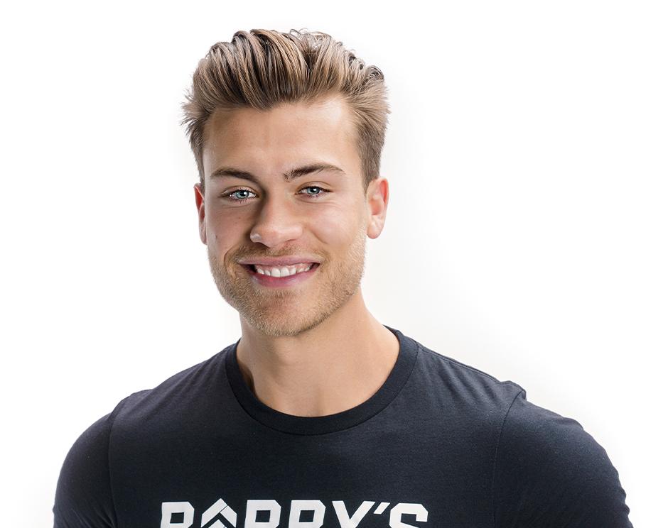 Barry's instructor standing confidently wearing a black top against a white background.