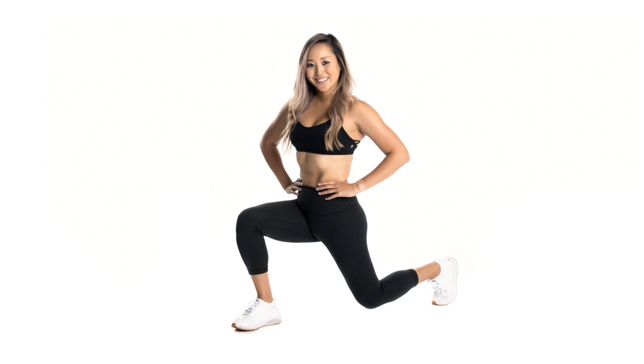 Barry's instructor in a lunge wearing a black top and leggings against a white background.