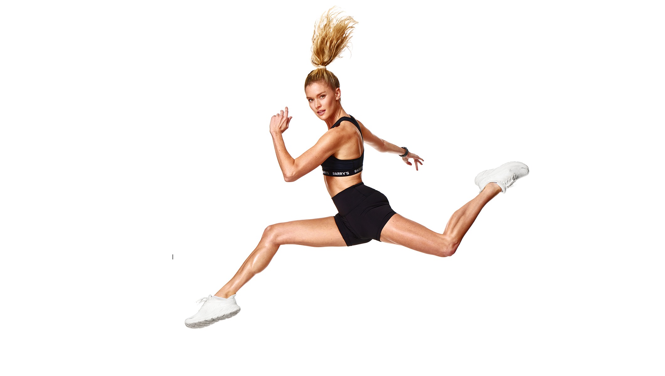 Barry's instructor running wearing a black top against a white background.