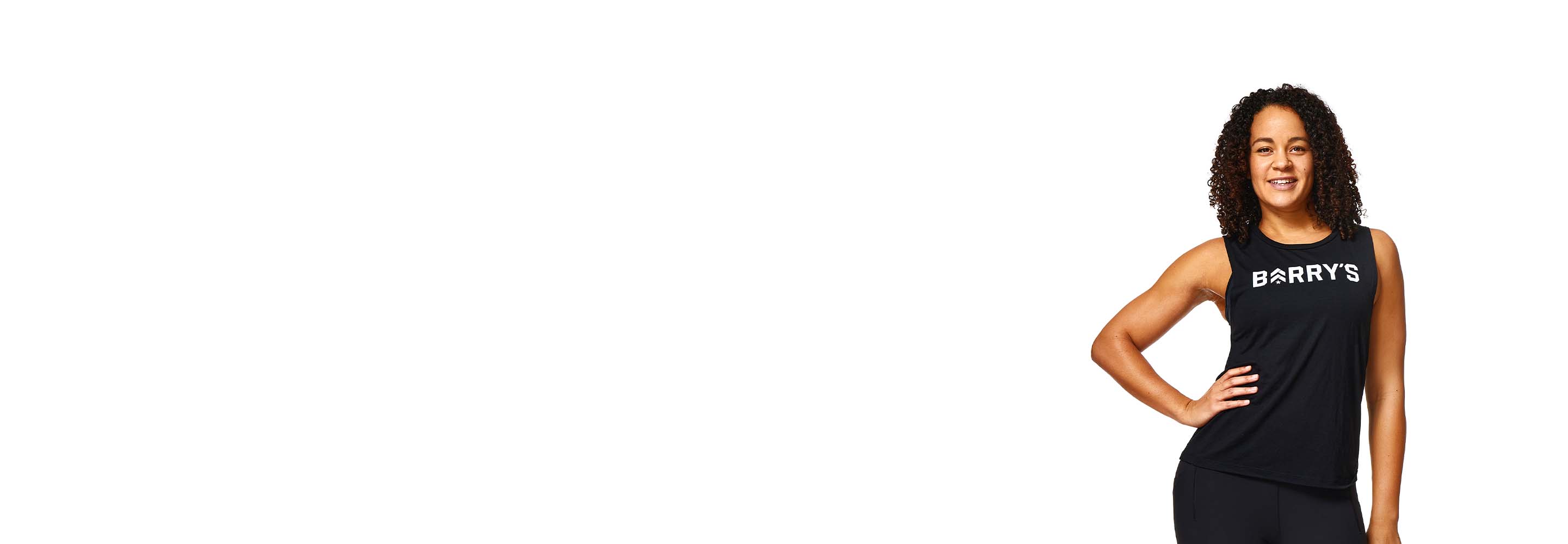 Barrys instruktör står självsäkert klädd i en svart topp mot en vit bakgrund.