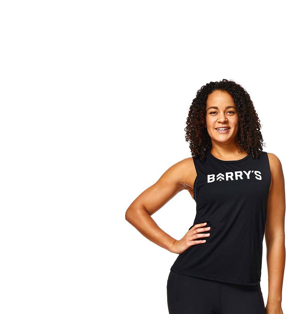 Barrys instruktör står självsäkert klädd i en svart topp mot en vit bakgrund.