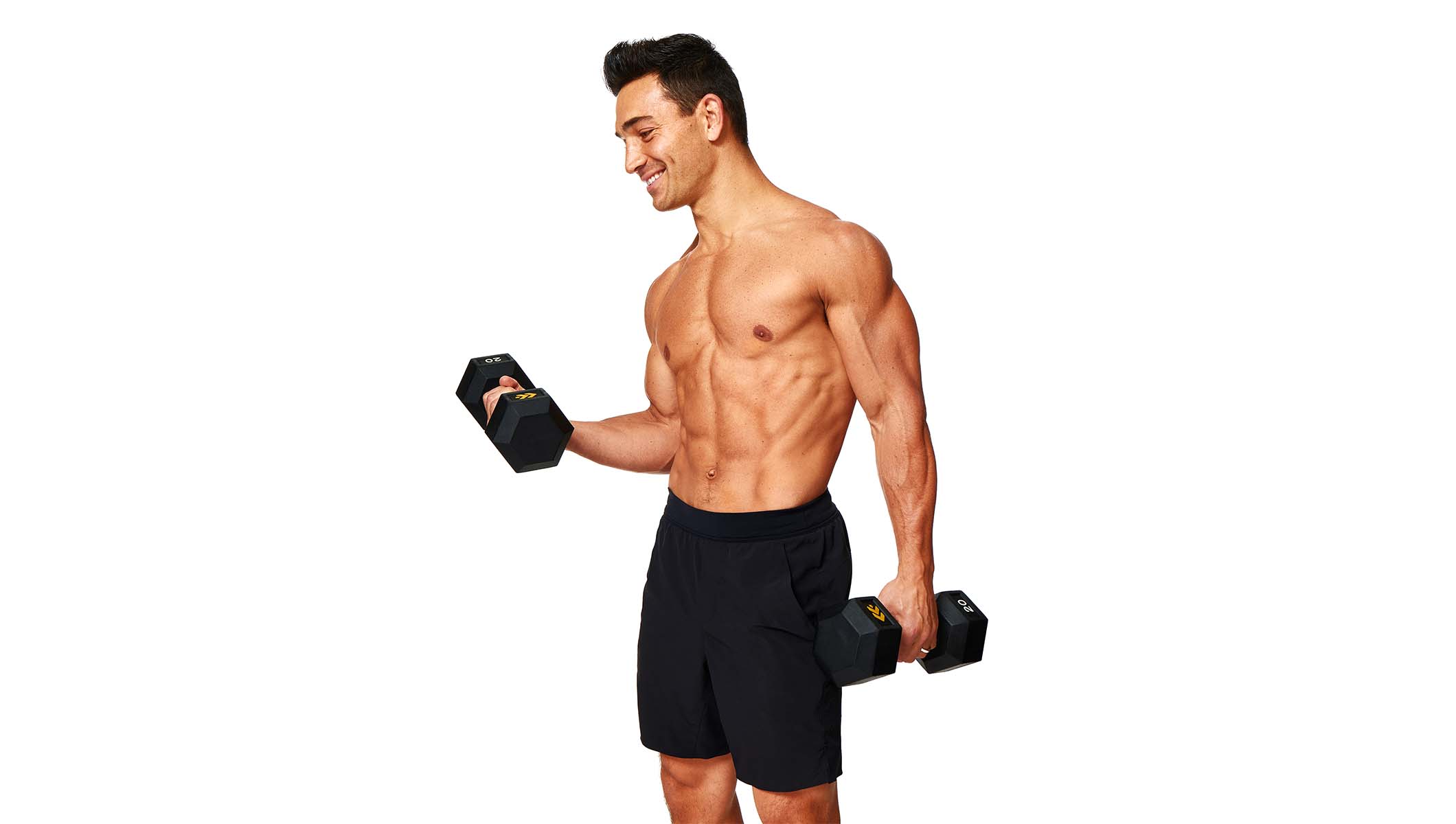 Barry’s instructor shirtless wearing black shorts holding weights out to the side
